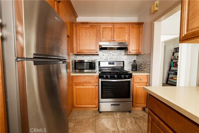 kitchen featuring tasteful backsplash, light tile patterned floors, and appliances with stainless steel finishes