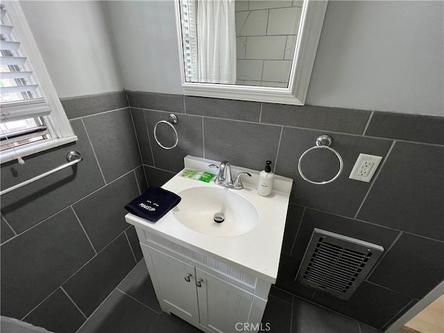 bathroom featuring tile walls and vanity