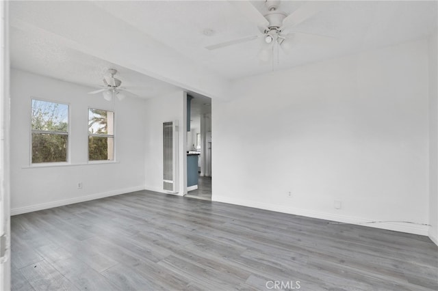 unfurnished room featuring wood-type flooring and ceiling fan