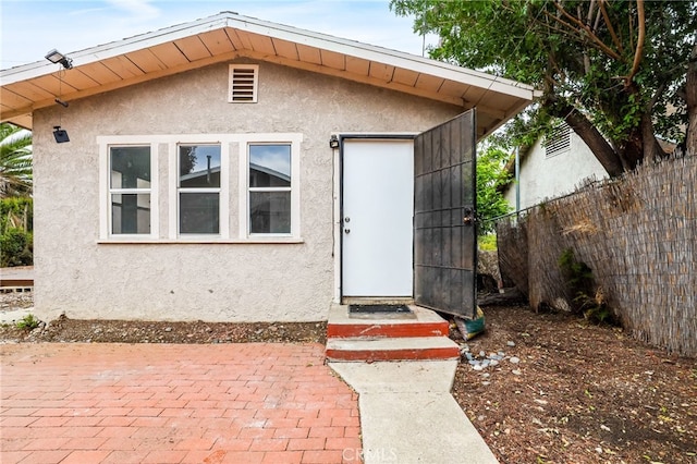 view of exterior entry featuring a patio