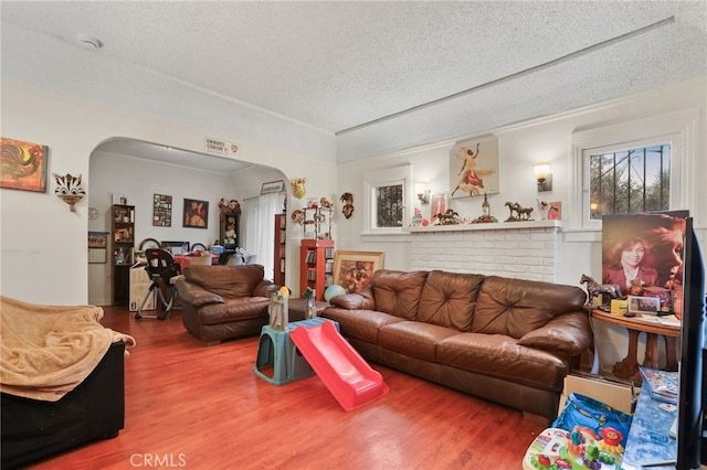 living room with hardwood / wood-style floors and a textured ceiling