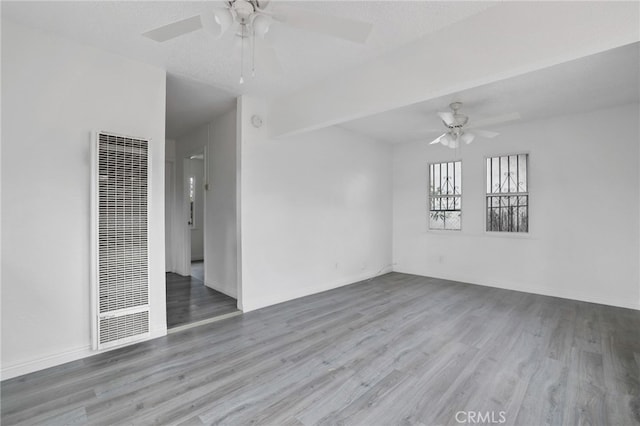 spare room featuring a textured ceiling, light hardwood / wood-style floors, and ceiling fan