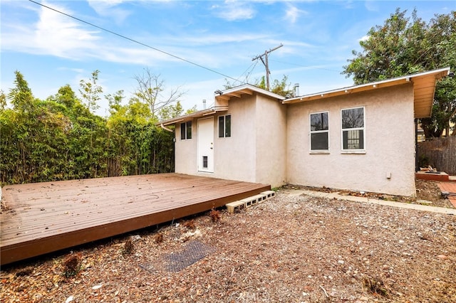 back of property featuring a wooden deck