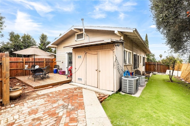 view of outdoor structure with a yard and central AC unit