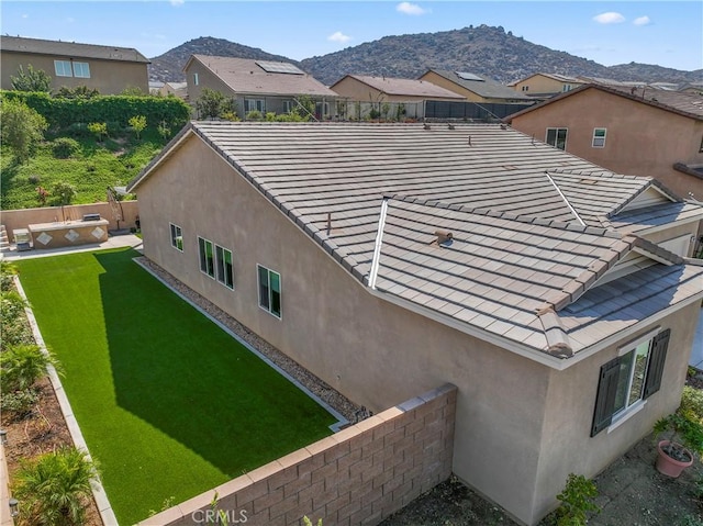 exterior space featuring a mountain view and a lawn