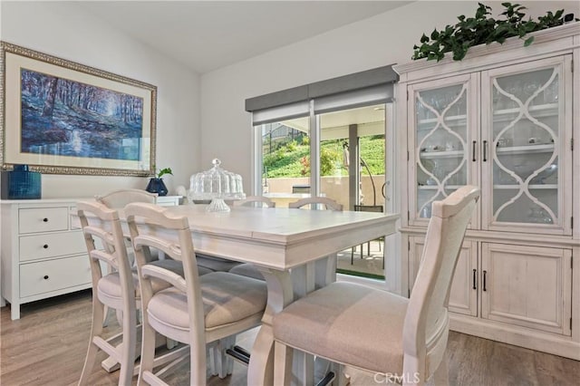 dining space with wood-type flooring