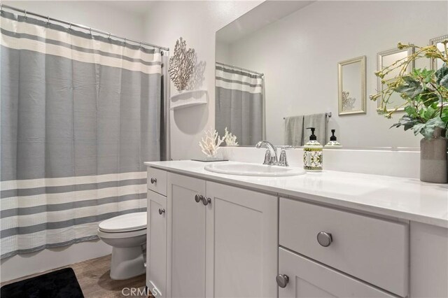 full bathroom featuring vanity, toilet, and shower / tub combo