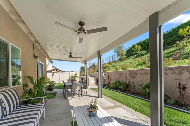 view of patio featuring ceiling fan