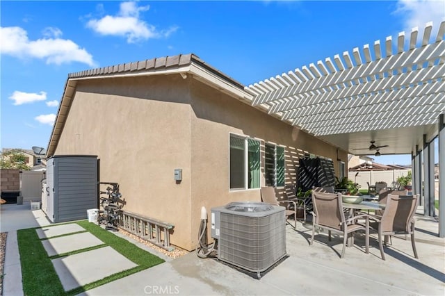 exterior space featuring central AC unit, a pergola, a patio, and ceiling fan