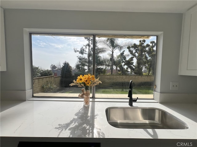 room details with sink and light stone countertops