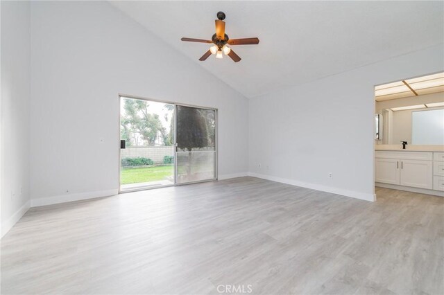 spare room featuring sink, high vaulted ceiling, ceiling fan, and light wood-type flooring