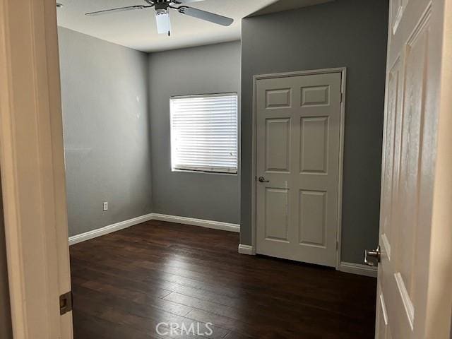 unfurnished bedroom with dark wood-type flooring and ceiling fan