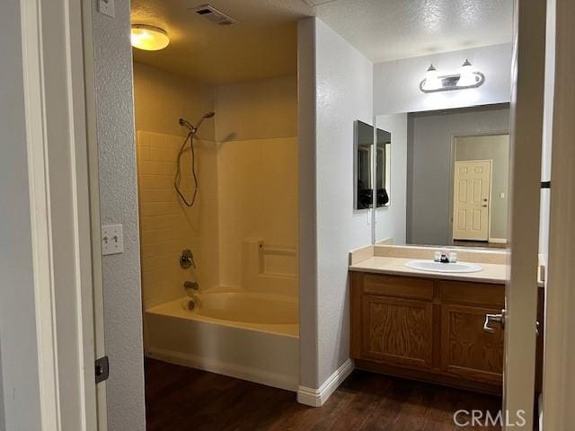 bathroom with wood-type flooring, bathtub / shower combination, and vanity