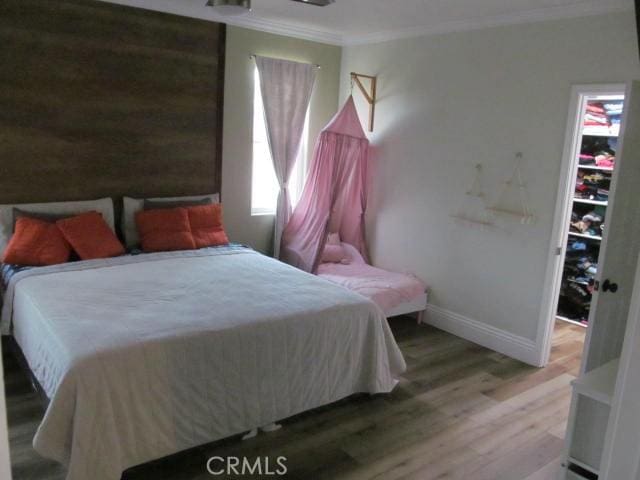 bedroom featuring hardwood / wood-style flooring and ornamental molding