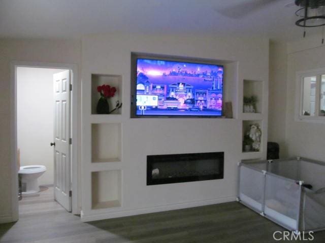 living room with hardwood / wood-style flooring and built in features