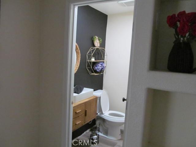 bathroom featuring vanity and toilet