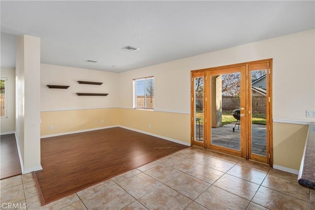 unfurnished room featuring light tile patterned floors