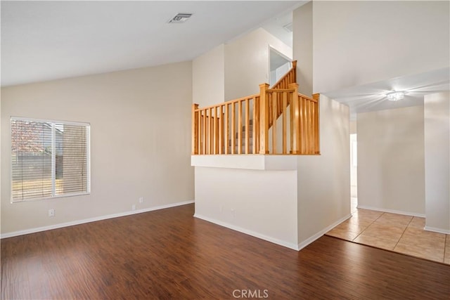 unfurnished living room with lofted ceiling and hardwood / wood-style floors