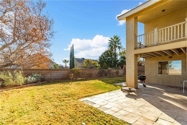 view of yard featuring a balcony and a patio area