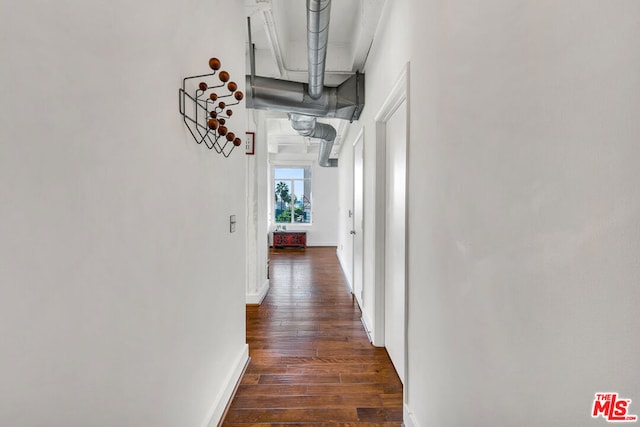 corridor featuring dark hardwood / wood-style flooring