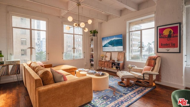 sitting room with beam ceiling and dark wood-type flooring