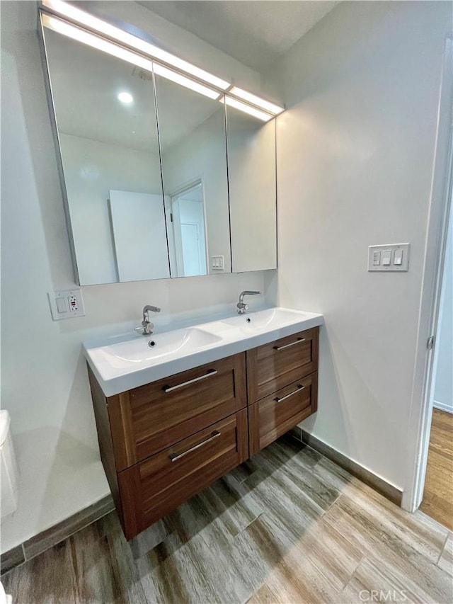 bathroom with hardwood / wood-style flooring and vanity