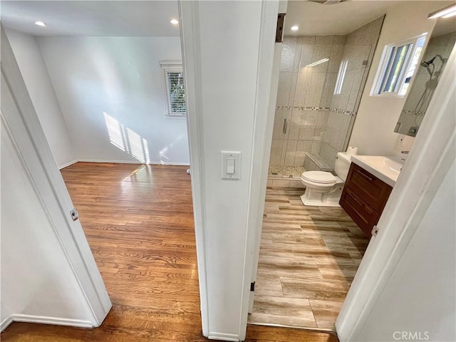 bathroom featuring vanity, an enclosed shower, hardwood / wood-style flooring, and toilet