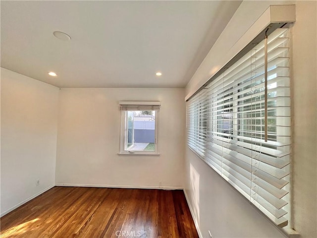 unfurnished room with dark hardwood / wood-style flooring