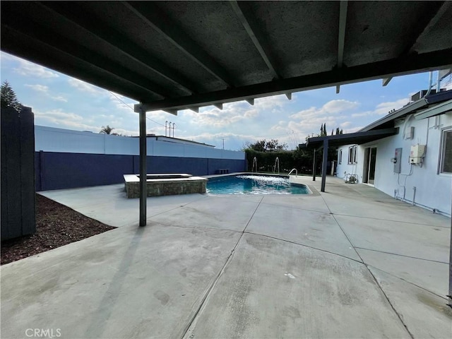 view of pool featuring an in ground hot tub and a patio