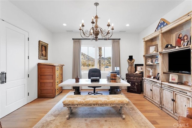 home office featuring a chandelier and light hardwood / wood-style flooring