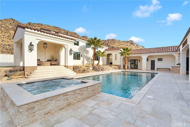 back of house with a pool with hot tub and a patio area