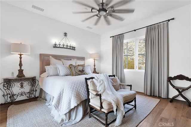 bedroom with hardwood / wood-style flooring and ceiling fan