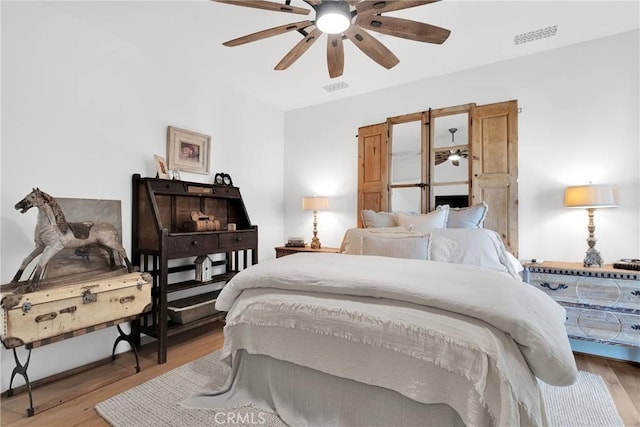 bedroom with ceiling fan and light hardwood / wood-style flooring