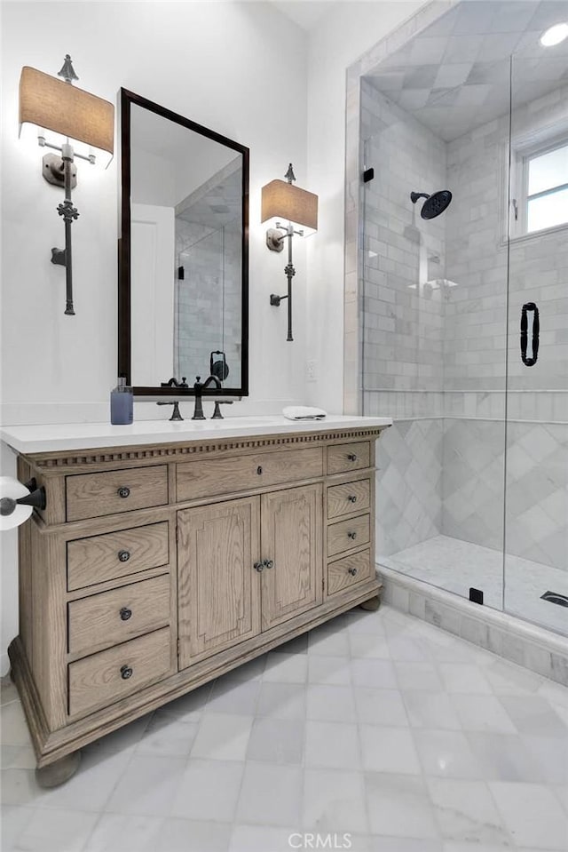 bathroom with vanity and a shower with door