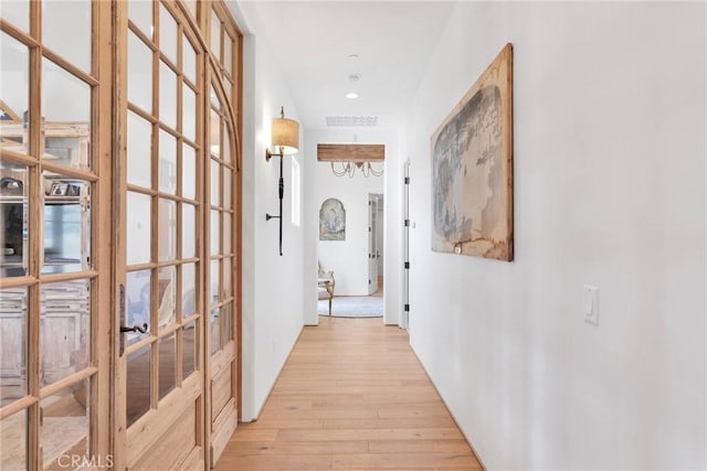 corridor featuring light hardwood / wood-style floors