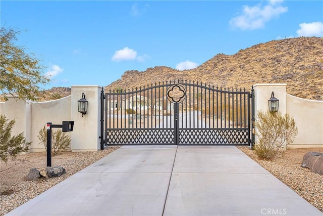 view of gate with a mountain view