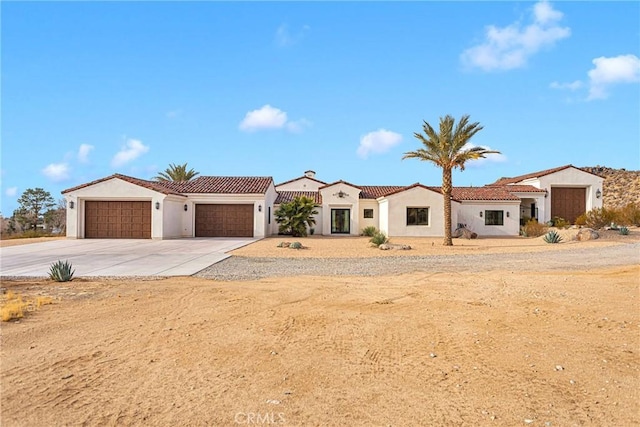 mediterranean / spanish house featuring a garage