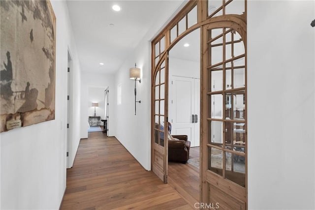 hallway featuring hardwood / wood-style flooring and french doors