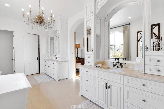 bathroom featuring vanity and a washtub