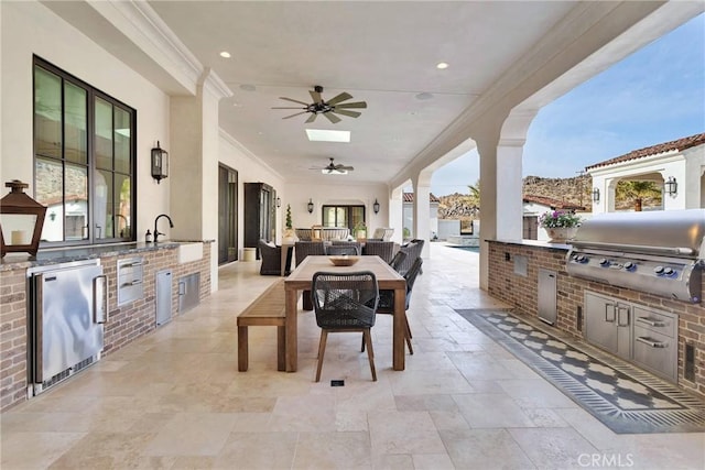 view of patio featuring ceiling fan, area for grilling, and a grill