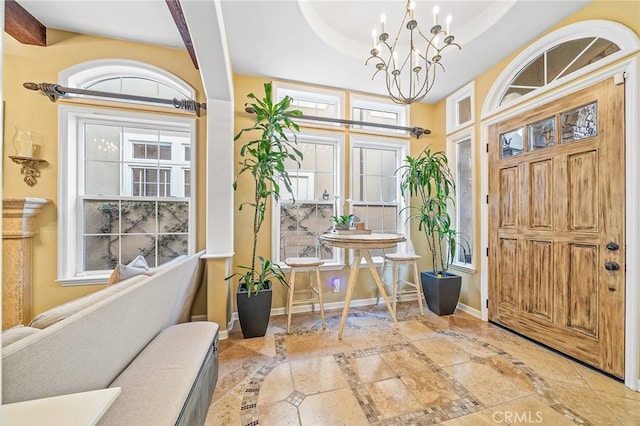 entrance foyer featuring a notable chandelier and a tray ceiling