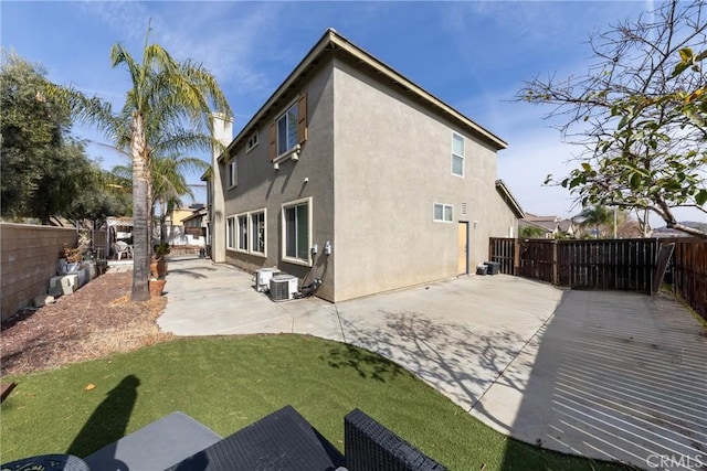 rear view of property featuring a lawn and a patio