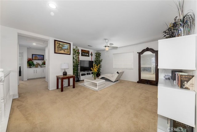 living room with light carpet and ceiling fan