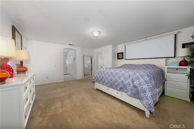 carpeted bedroom featuring connected bathroom