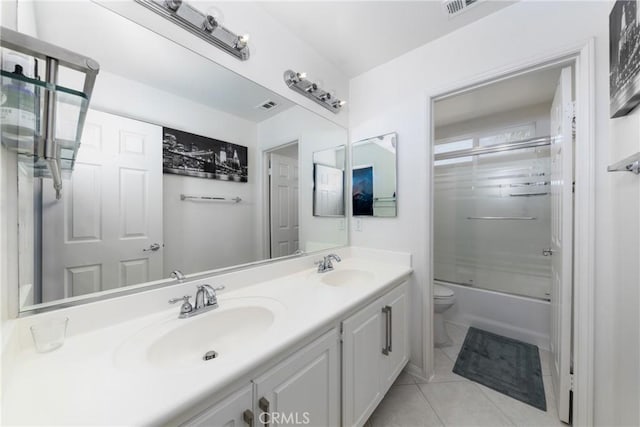 full bathroom featuring toilet, tile patterned floors, vanity, and shower / bath combination with glass door