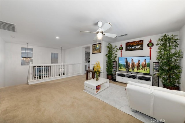 carpeted living room with ceiling fan