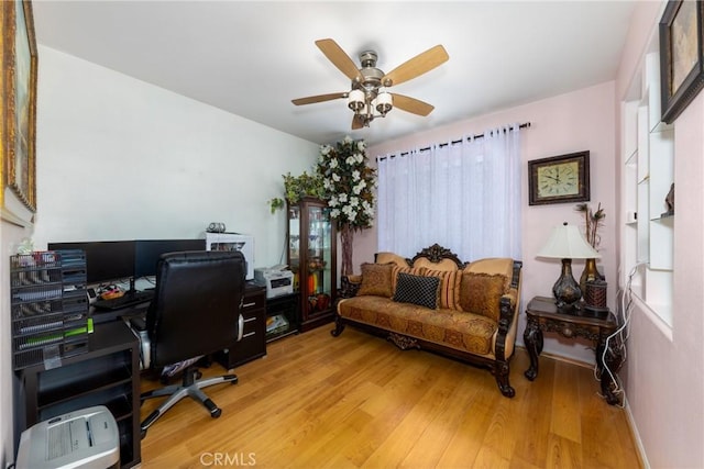 home office featuring ceiling fan and light hardwood / wood-style floors