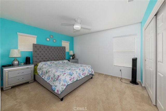 bedroom with light carpet, a closet, and ceiling fan