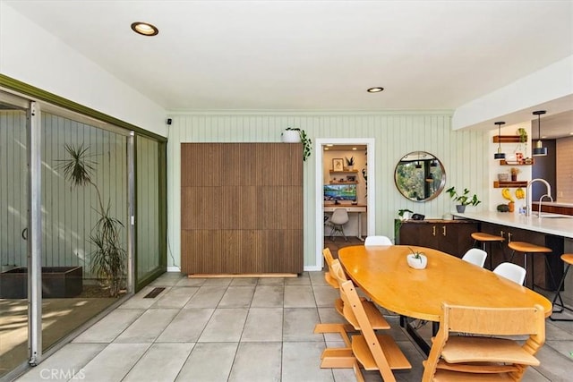 dining space with sink and light tile patterned floors