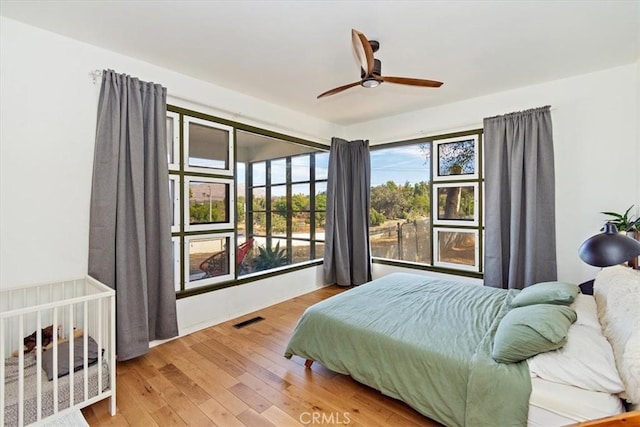 bedroom featuring hardwood / wood-style flooring and ceiling fan